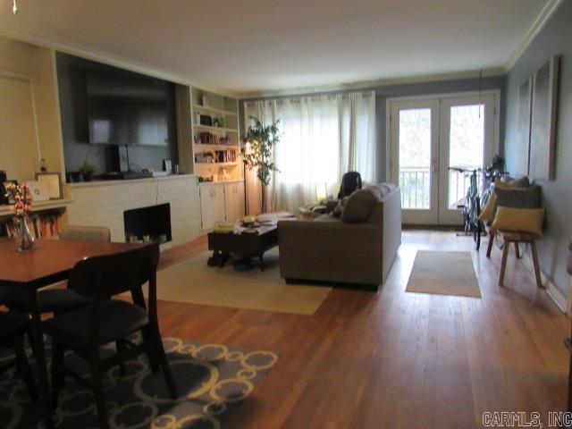 living room with hardwood / wood-style flooring, a fireplace, and french doors