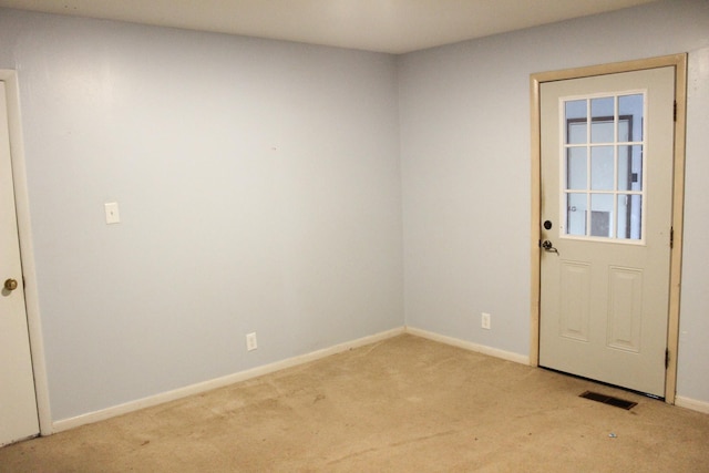 doorway to outside with light colored carpet