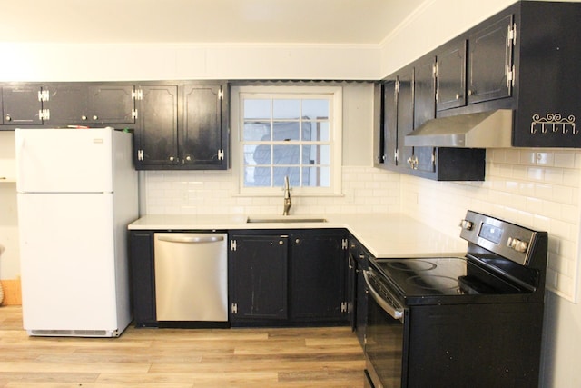 kitchen with sink, dishwasher, range with electric cooktop, white refrigerator, and light hardwood / wood-style floors