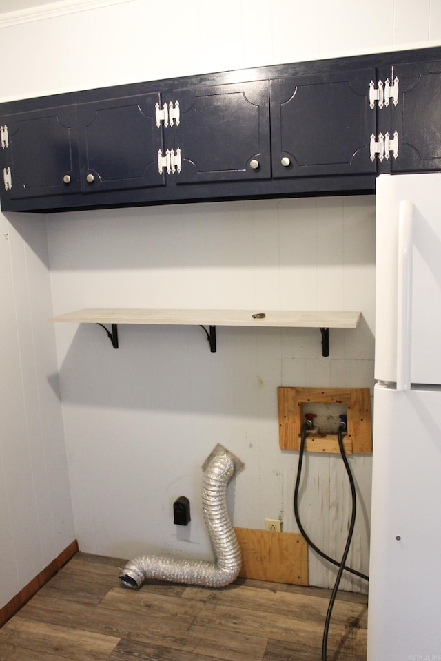 washroom with washer hookup, cabinets, dark hardwood / wood-style flooring, and electric dryer hookup