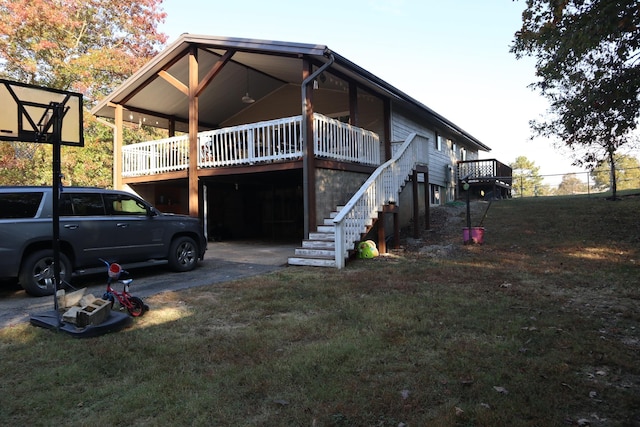 back of house featuring a wooden deck and a yard