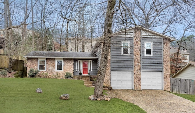 tri-level home featuring a garage and a front lawn