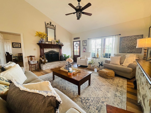 living room with light hardwood / wood-style flooring, high vaulted ceiling, and ceiling fan