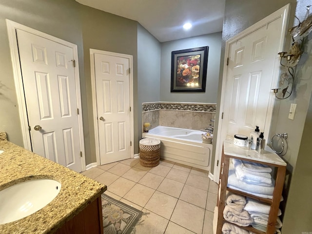 bathroom with vanity, a bath, and tile patterned floors