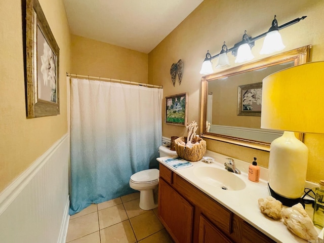 bathroom with tile patterned flooring, vanity, toilet, and walk in shower