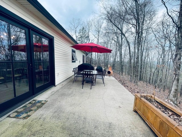 view of patio with a fireplace