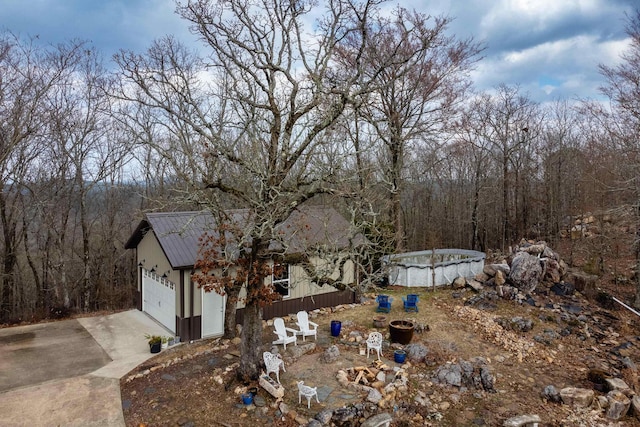 view of yard featuring a garage and a covered pool