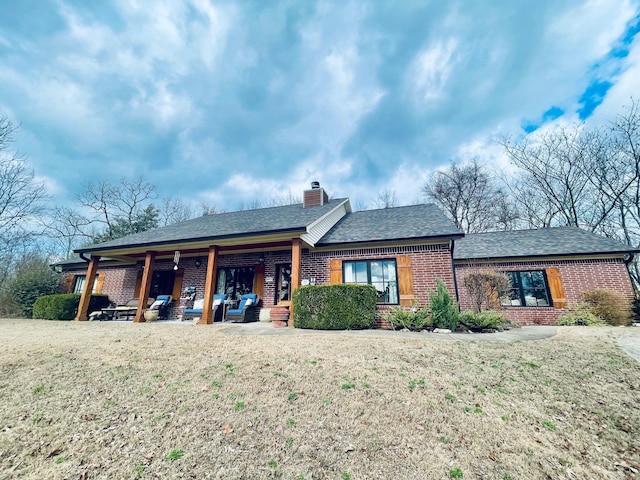 back of property featuring a yard