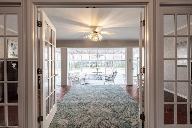 sunroom / solarium featuring french doors and ceiling fan