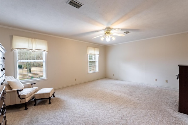 living area featuring crown molding, light colored carpet, and ceiling fan