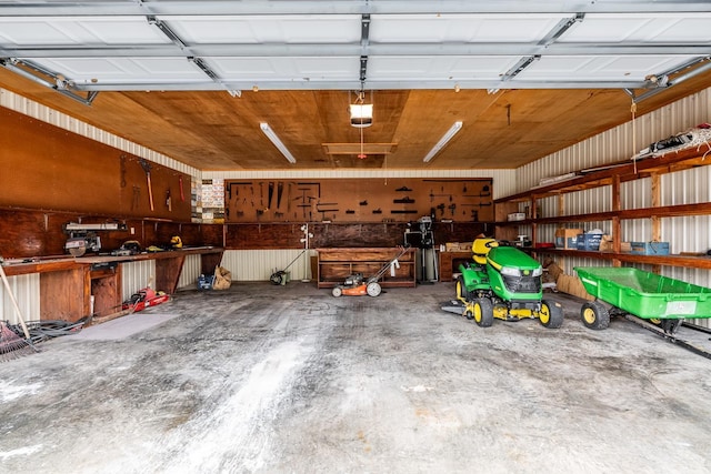 garage with a garage door opener and a workshop area