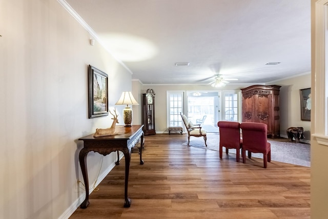 interior space with crown molding, hardwood / wood-style flooring, and ceiling fan