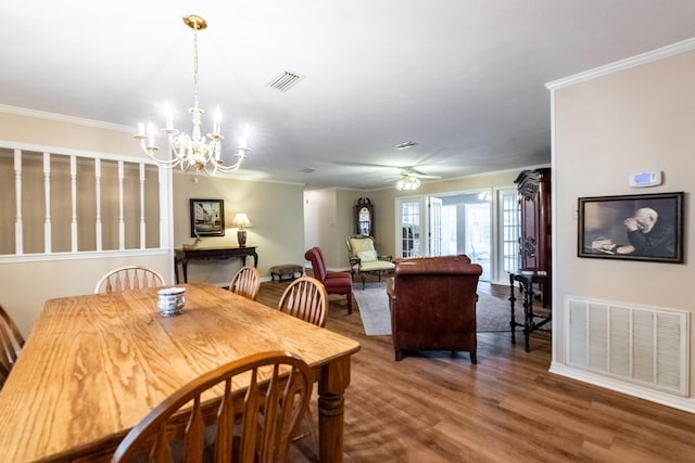 dining room with crown molding, wood-type flooring, and ceiling fan with notable chandelier