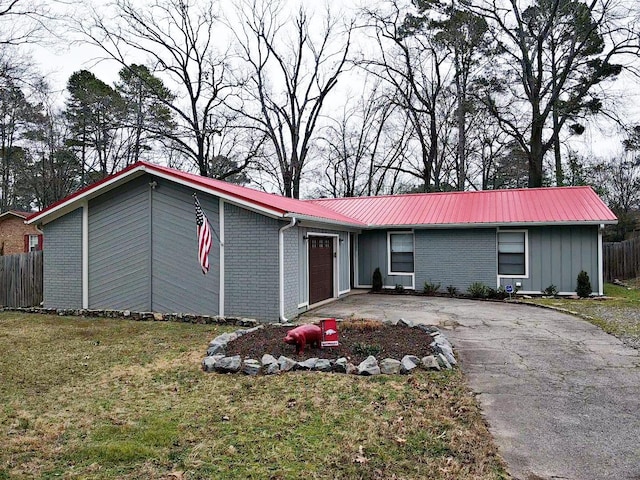 single story home with a garage and a front yard