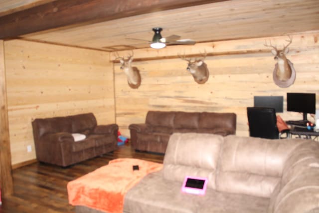 living room featuring ceiling fan, wood ceiling, dark hardwood / wood-style flooring, and wood walls