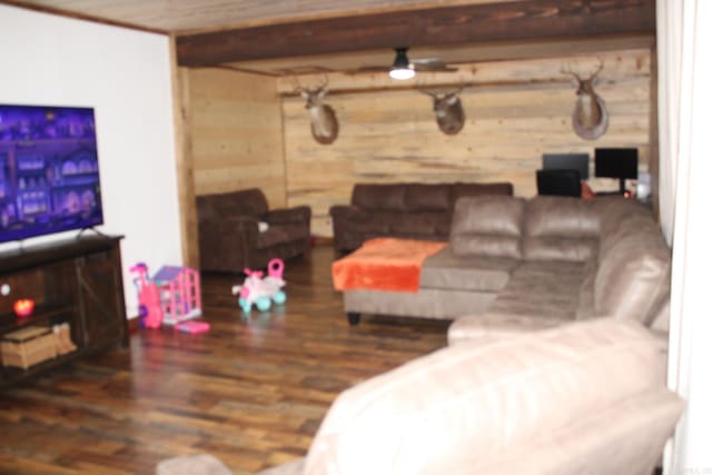 living room with beamed ceiling and dark hardwood / wood-style flooring