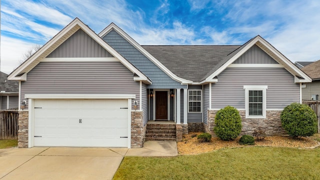 craftsman house with a garage and a front yard