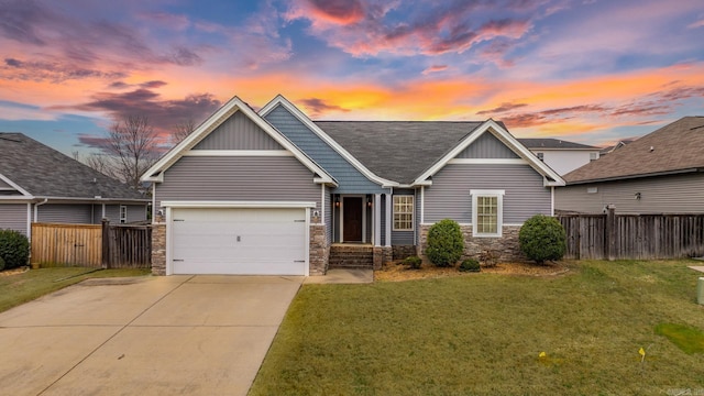 craftsman-style house with a garage and a lawn