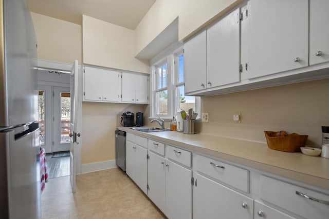 kitchen featuring white cabinetry, sink, and appliances with stainless steel finishes