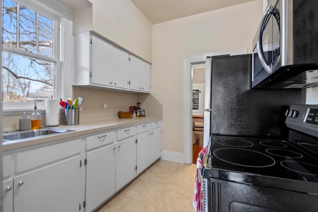 kitchen featuring sink, white cabinets, and electric stove