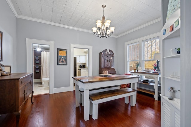 dining space with dark wood-type flooring, crown molding, and a notable chandelier