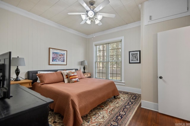 bedroom featuring ceiling fan, ornamental molding, and dark hardwood / wood-style floors