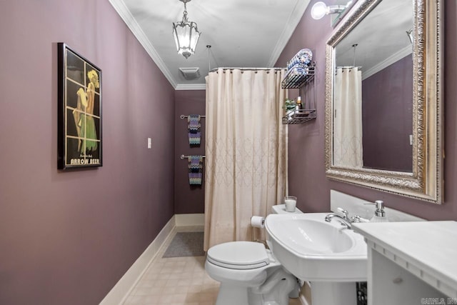 bathroom with ornamental molding and toilet