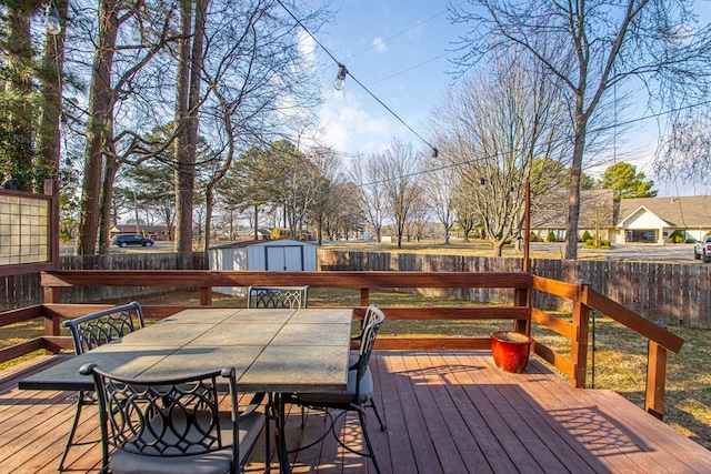 wooden terrace featuring a storage shed