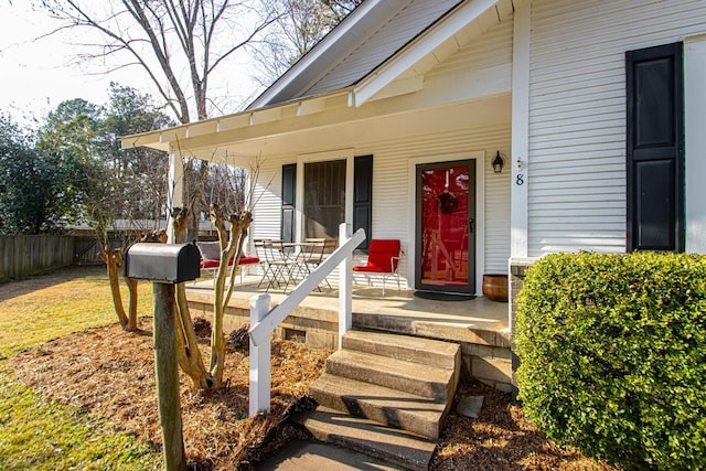 view of exterior entry with covered porch