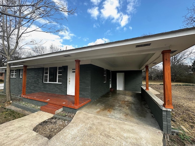 view of front of property featuring a carport and covered porch