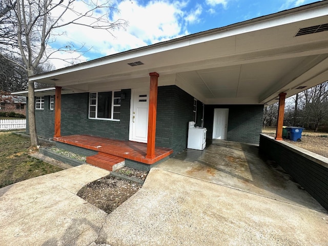 single story home with a carport and washer / dryer