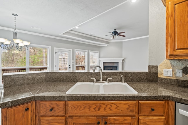 kitchen with sink, stainless steel dishwasher, plenty of natural light, and ornamental molding