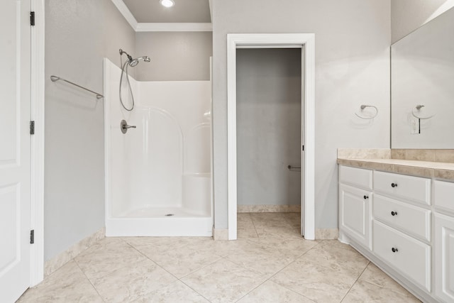 bathroom featuring ornamental molding, vanity, tile patterned floors, and walk in shower