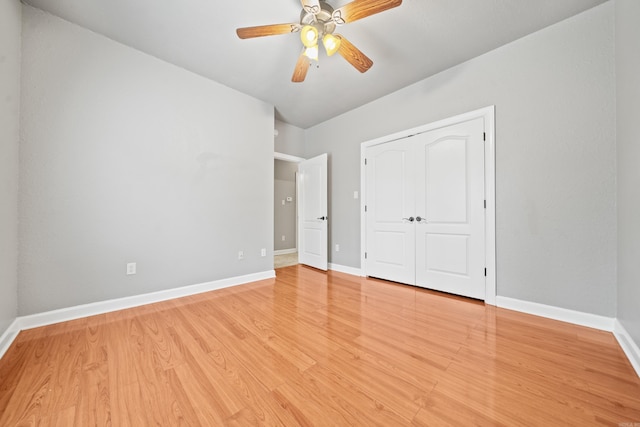 unfurnished bedroom featuring ceiling fan, light hardwood / wood-style floors, and a closet