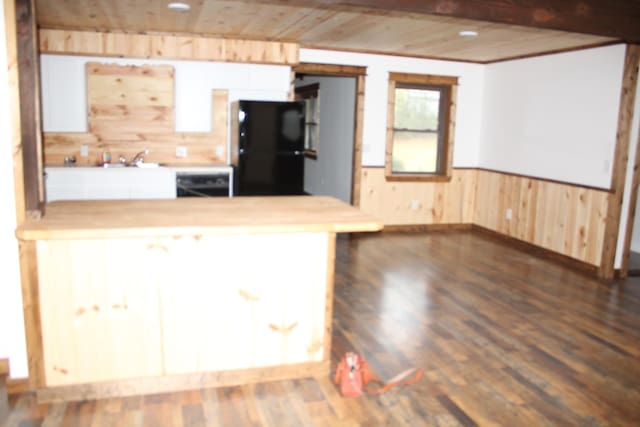 kitchen featuring black fridge, wooden ceiling, dark hardwood / wood-style flooring, and kitchen peninsula