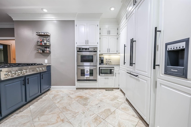 kitchen featuring built in appliances, crown molding, blue cabinetry, and white cabinets