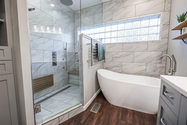 bathroom featuring vanity, wood-type flooring, and independent shower and bath