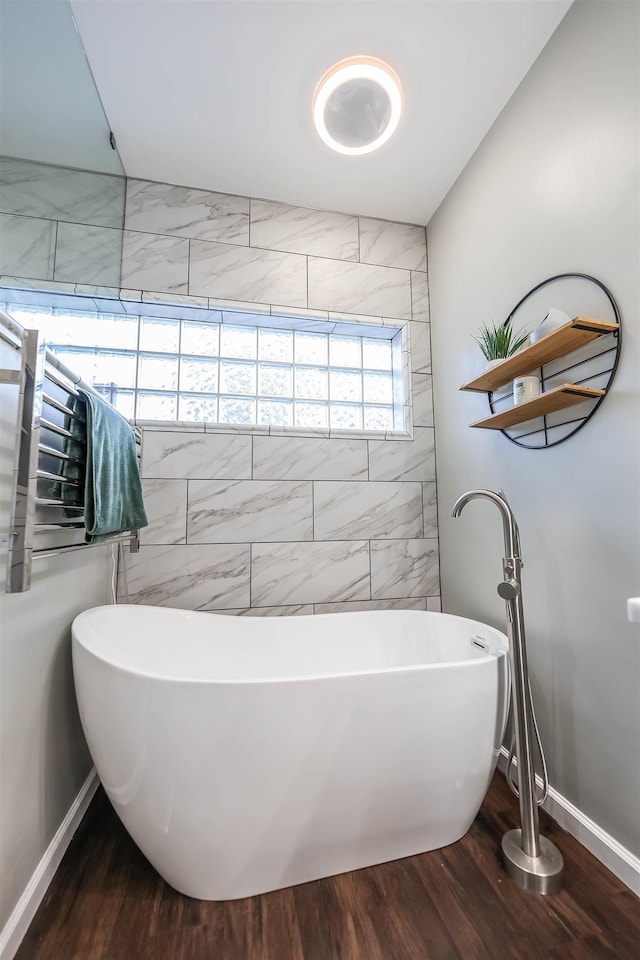 bathroom featuring a bath and hardwood / wood-style flooring