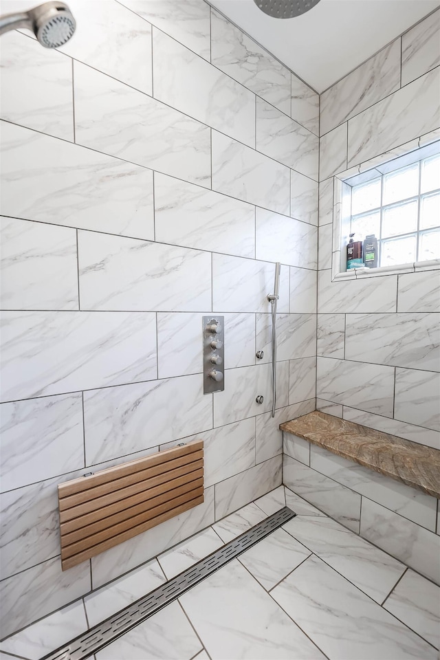 bathroom with a tile shower