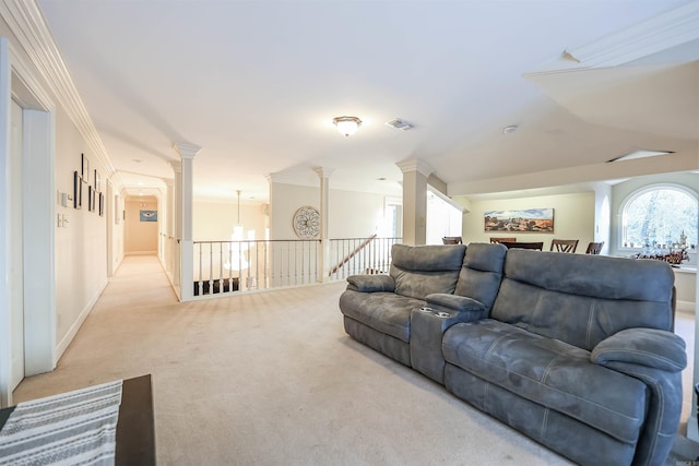 carpeted living room featuring ornate columns