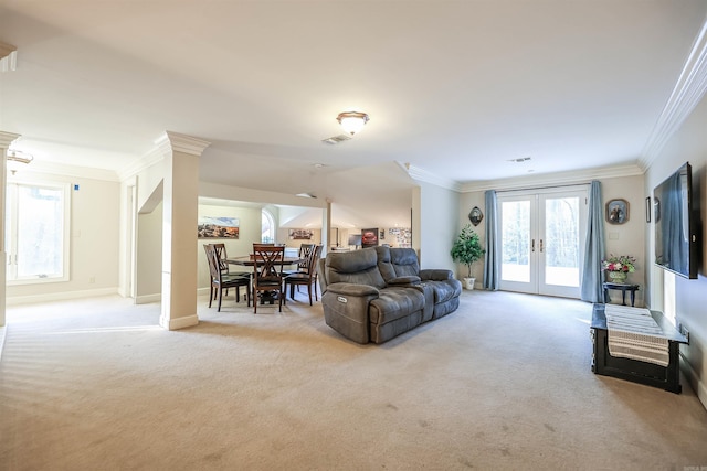 living room featuring light carpet, ornamental molding, and french doors