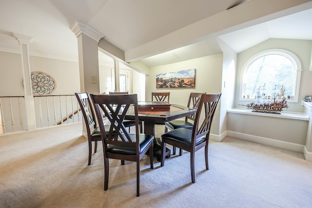 dining space featuring light colored carpet, lofted ceiling, and decorative columns