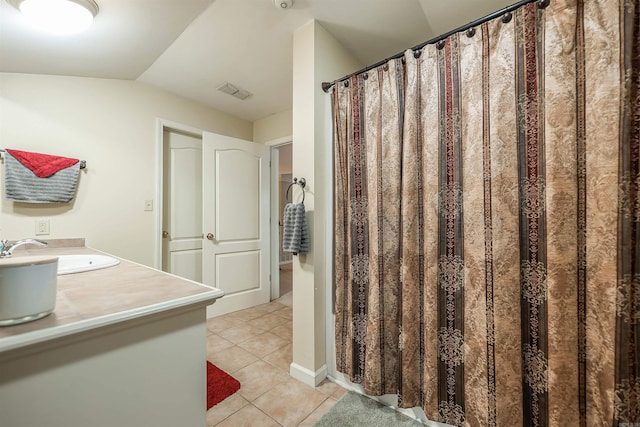 bathroom with tile patterned flooring and vanity