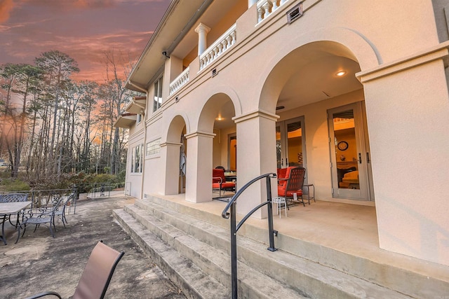 view of patio terrace at dusk