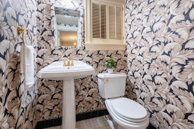 bathroom featuring tile patterned floors and toilet