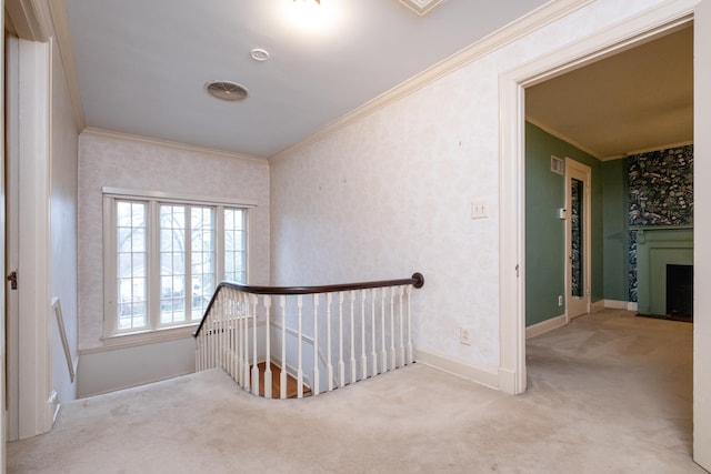 staircase with crown molding and carpet flooring