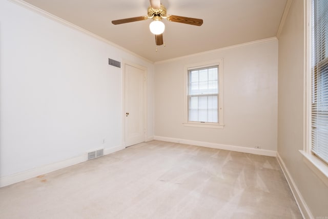 spare room with light carpet, crown molding, and ceiling fan