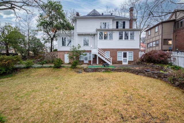 rear view of property with a yard