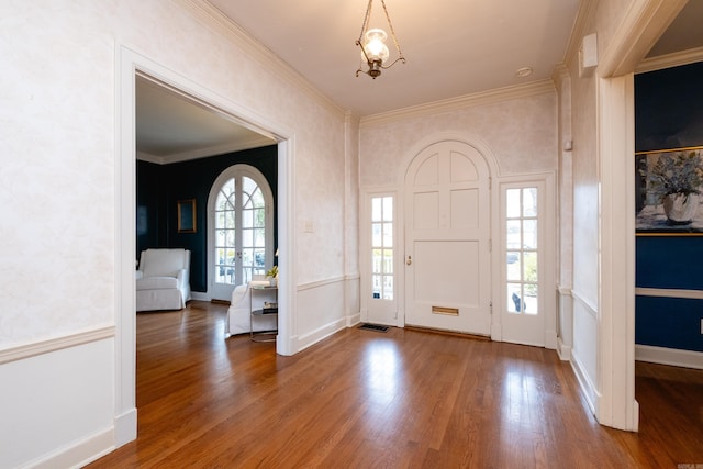 foyer featuring ornamental molding and wood-type flooring