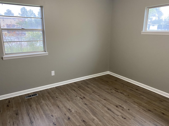 spare room with dark hardwood / wood-style floors